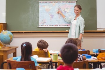 Teacher giving a geography lesson in classroom