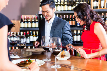 Asian friends celebrating in restaurant