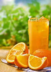 Fototapeta na wymiar Orange juice on the wood surface, outdoor