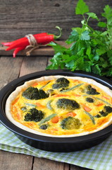 Vegetable pie tart with broccoli, peas, carrot and cheese.