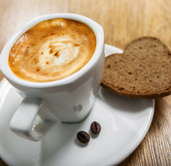 Cup of coffee with cookie heart