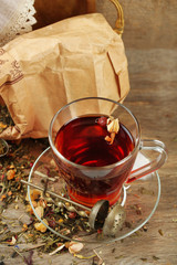 Beautiful vintage composition with herbal tea, on wooden table