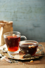 Beautiful vintage composition with herbal tea, on wooden table
