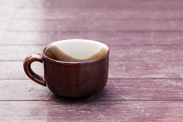 A cup on wood table.