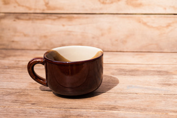 A cup on wood table.