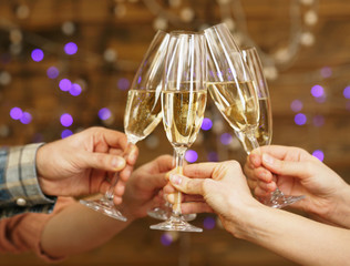 Clinking glasses of champagne in hands