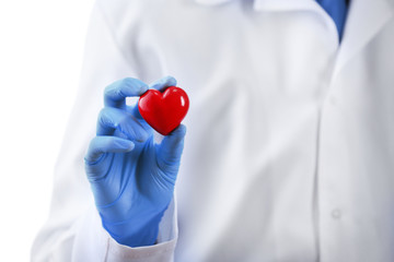 Doctor with stethoscope and small heart in hand