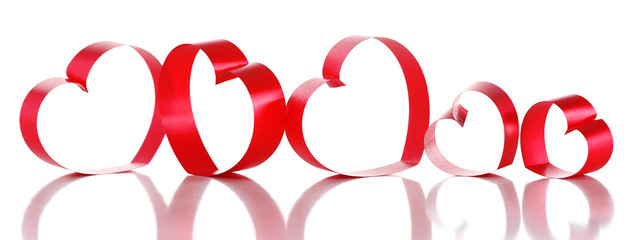 Red ribbons in shape of hearts isolated on white