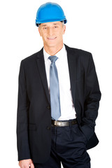 Businessman with hand in pocket wearing a helmet