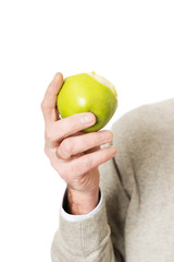 Male hand holding an apple