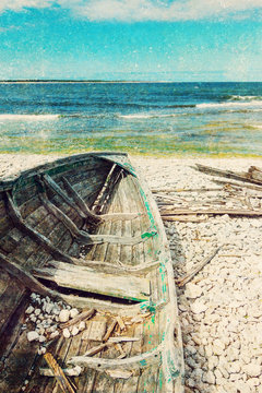 Old wooden boat on the seashore, retro image
