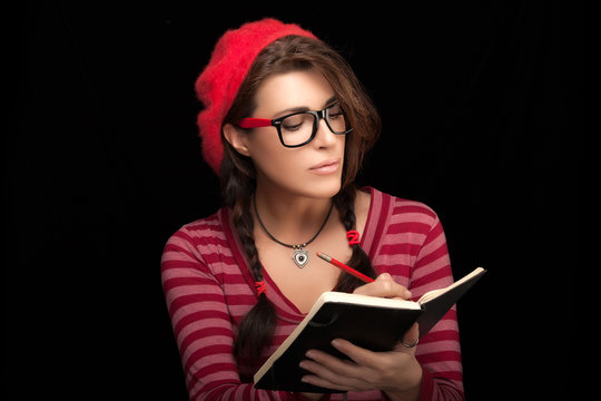 Pretty College Girl in Trendy Clothing Writing on her Notebook