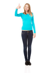 Fototapeta premium Happy female student showing thumbs up