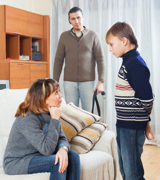 Parents scolding  son in home