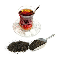 Turkish tea in traditional glass and dry black tea leaves