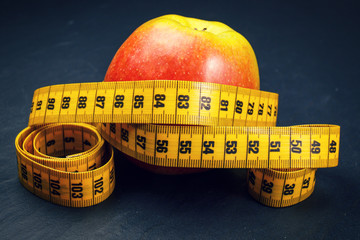 apple with yellow measuring tape
