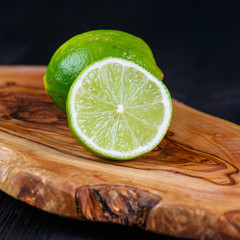 green lemons on the wooden table