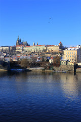 Fototapeta na wymiar Snowy Prague gothic Castle above River Vltava, Czech Republic