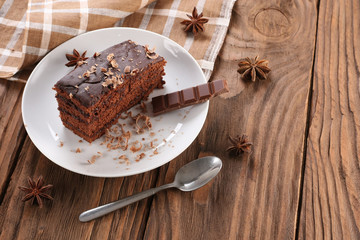 chocolate cake on a plate on a wooden boards background