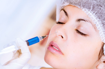 closeup of woman receiving cosmetic injection through nose
