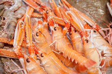 Detail of bunch of red fresh prawns in fish market