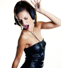 Sexy woman in disco dancing with headphones