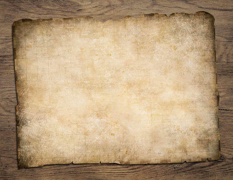 Old blank parchment treasure map on wooden table