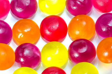 Close-up of colorful candy on white background.