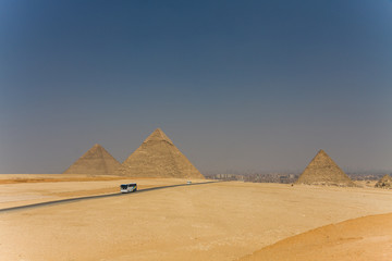 Fototapeta na wymiar The road through the desert. Egyptian pyramids.