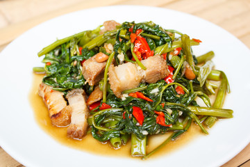 Fried morning glory with crispy pork.