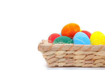 Easter eggs in basket on white background