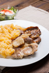Pork with mashed potatoes, closeup, vertical edit