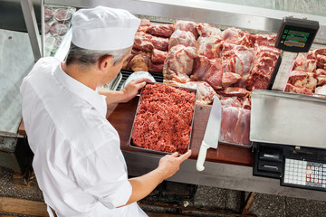 Butcher Holding Minced Meat Tray