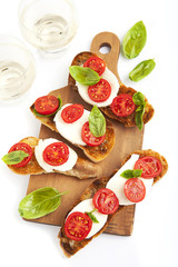 italian bruschetta with cherry tomatoes, mozzarella, fresh basil