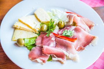 delicatessen plate with cheese ham and olives