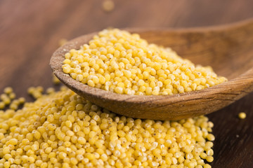 Millet on wooden spoon