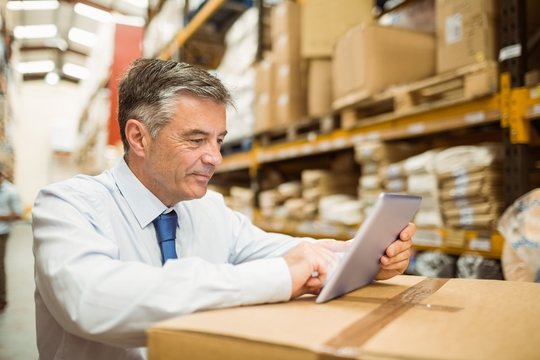 Warehouse Manager Working On Tablet Pc