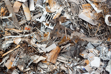 Ferrous scrap and mechanisms of various sizes seen from above.