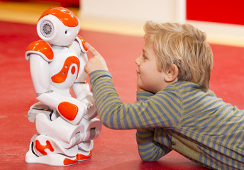 Child playing and learning with robot