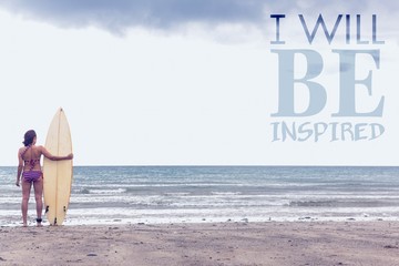 Fototapeta na wymiar Composite image of calm woman in bikini with surfboard on beach