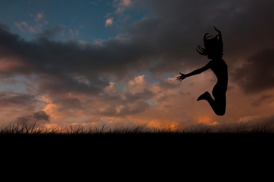 Composite image of silhouette of woman jumping