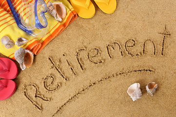 The word Retirement written in sand on a beach with towel flip flops and seashells old age summer...