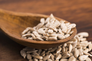 Sunflower seed with a wooden spoon