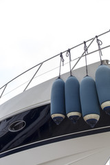 Big inflatable fenders on luxury yacht, space for text
