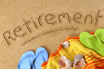 The word Retirement written in sand on a beach with towel flip flops and seashells old age summer holiday vacation photo