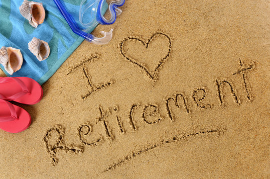 The word I Love Retirement written in sand on a beach with towel flip flops and seashells old age summer holiday vacation photo