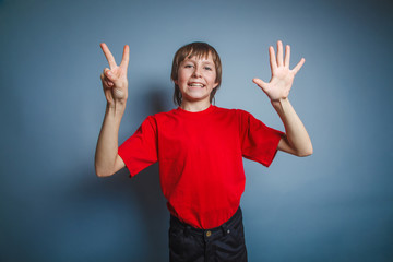 European-looking boy of ten years shows the number seven finger