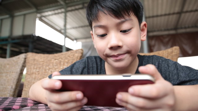 Asian child using a digital tablet together .