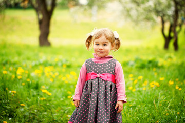 Beautiful  happy girl  playing in a field of yellow  flowers on