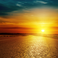 asphalt road closeup and sunset over it